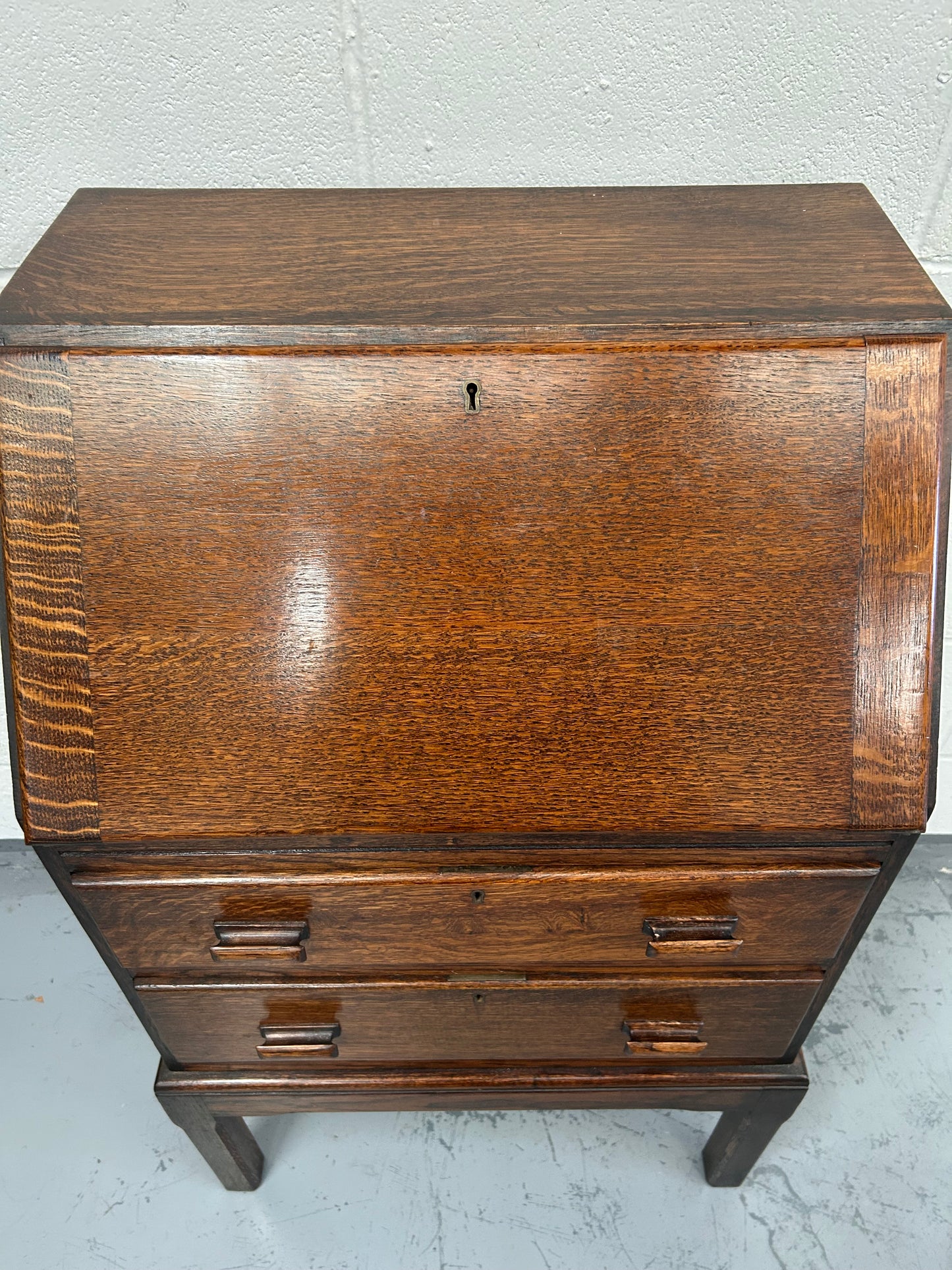 A lovely little vintage compact oak bureau with drop down writing surface and storage