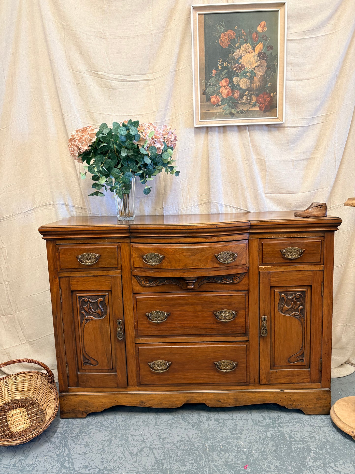 Edwardian Walnut sideboard featuring carved floral panels doors and brass hardware
