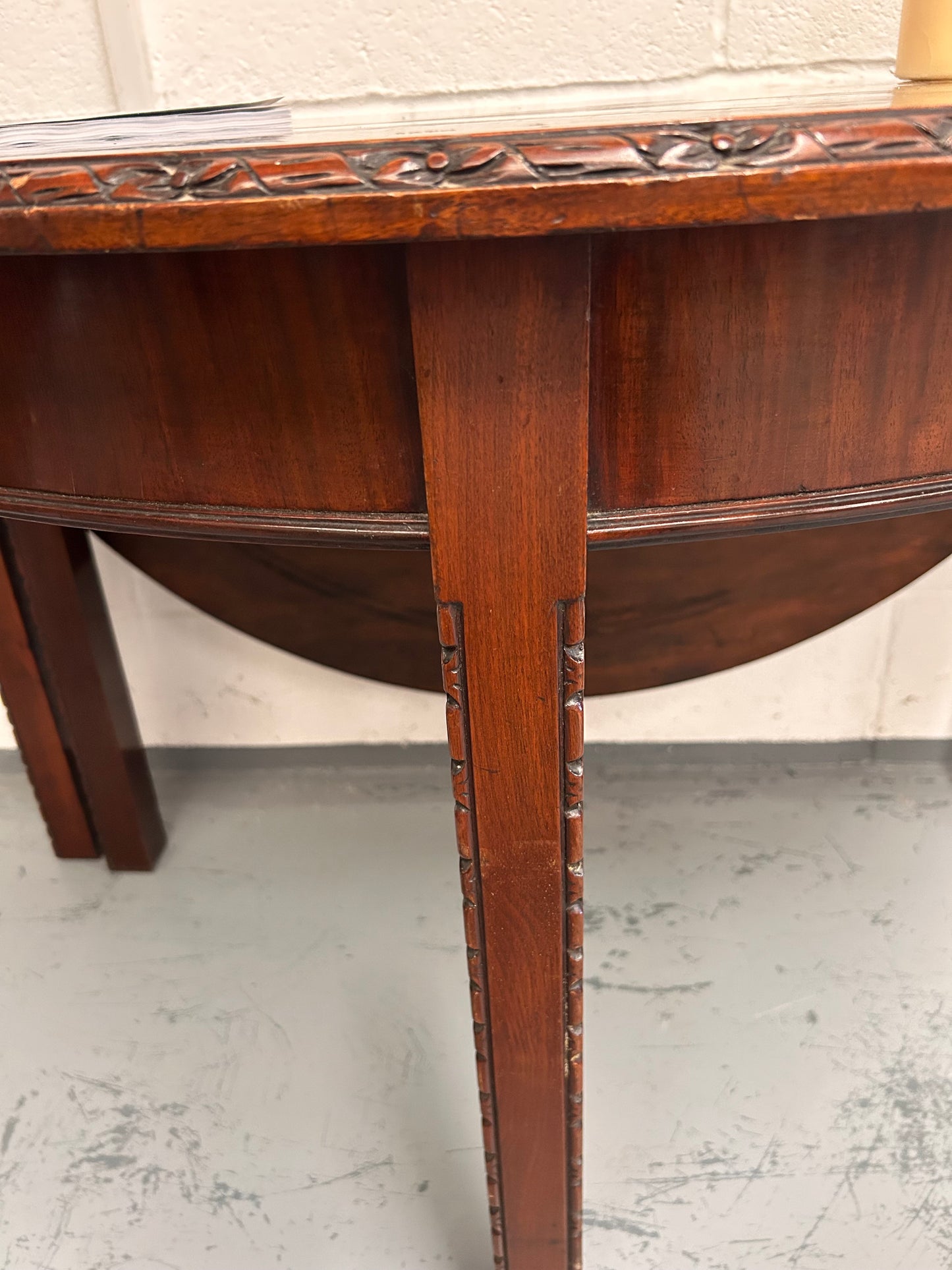 20th century demilune Table with carved edges and opens out to twice the size