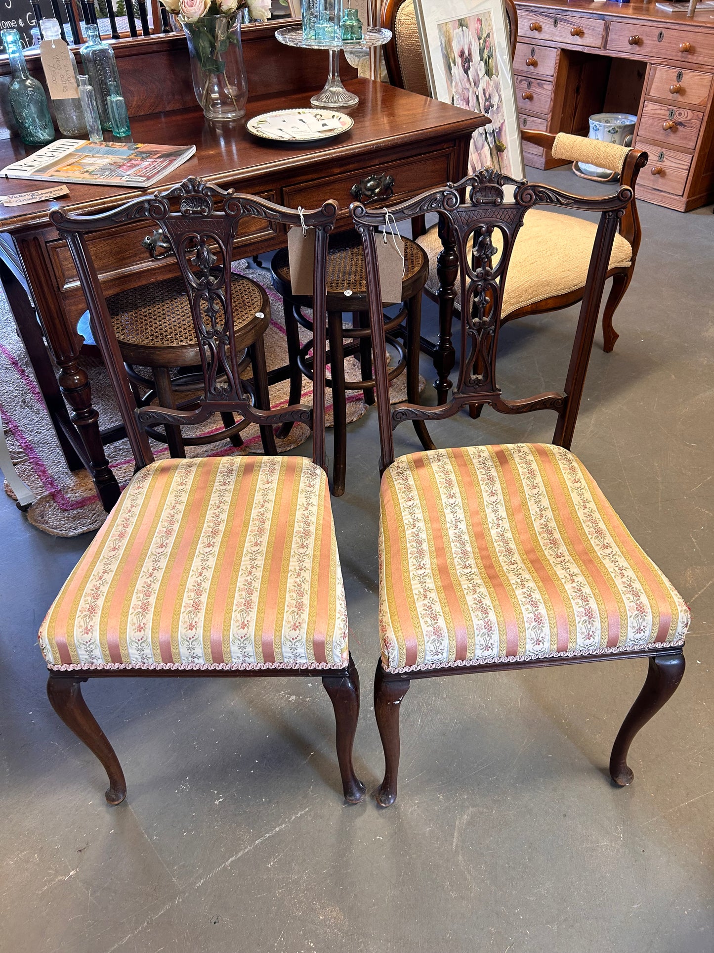 A pair of pretty pink fabric carved wood Edwardian chairs