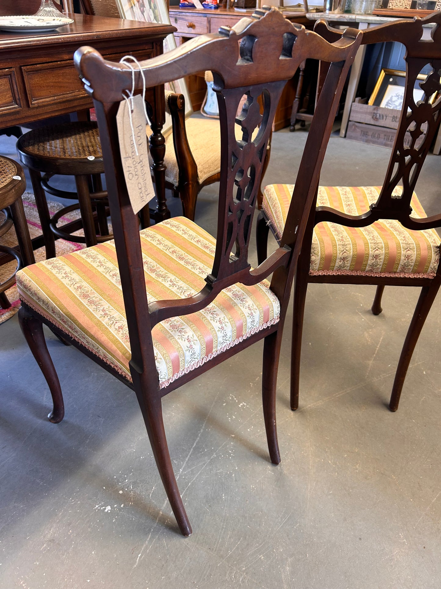 A pair of pretty pink fabric carved wood Edwardian chairs