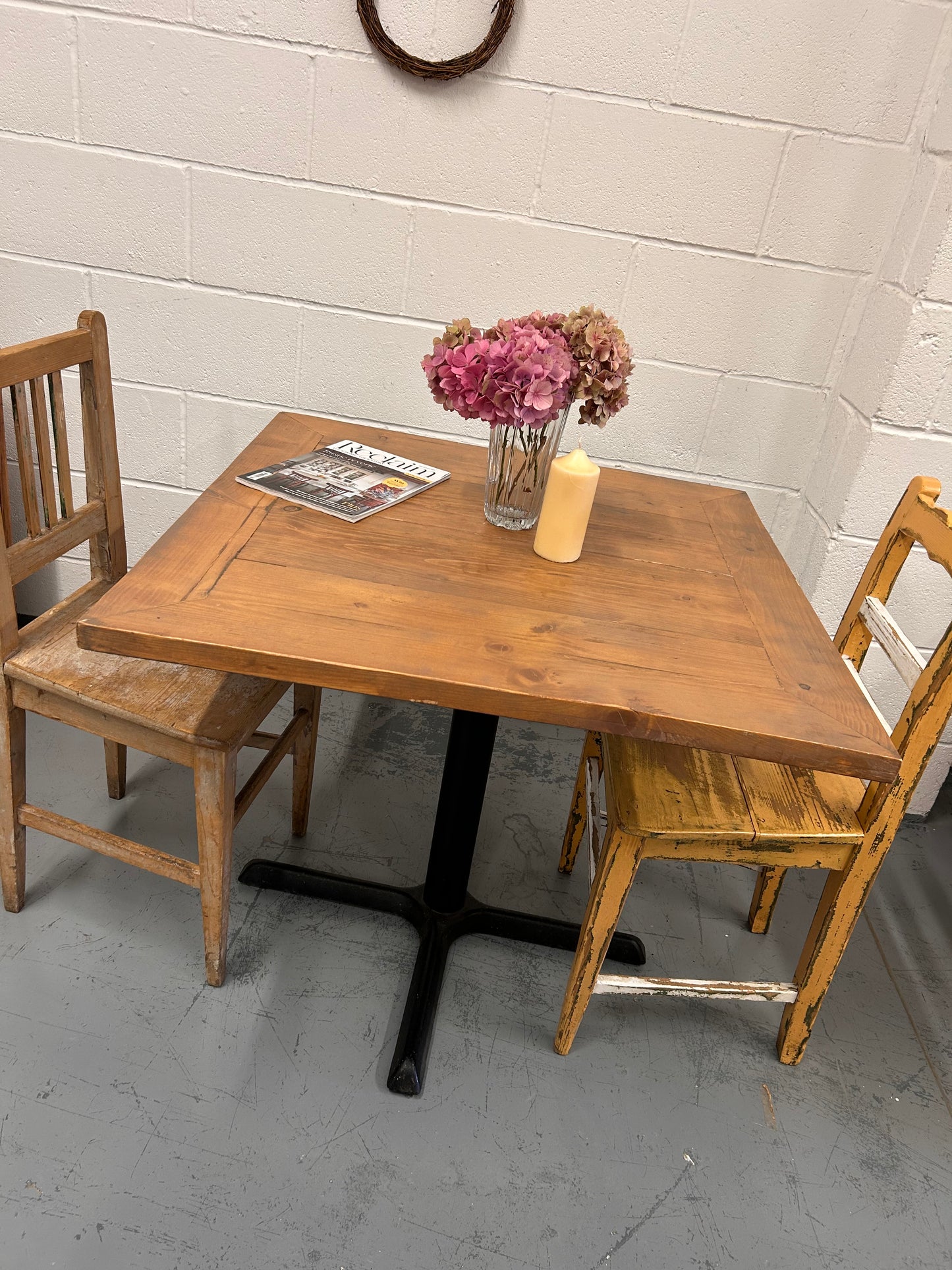 Preloved Rustic four seater table with thick wooden top and black metal base.