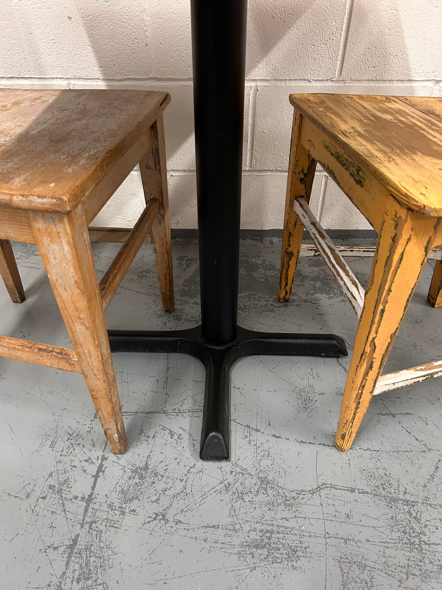 Rustic Preloved two seater table with thick wooden top and black metal base.