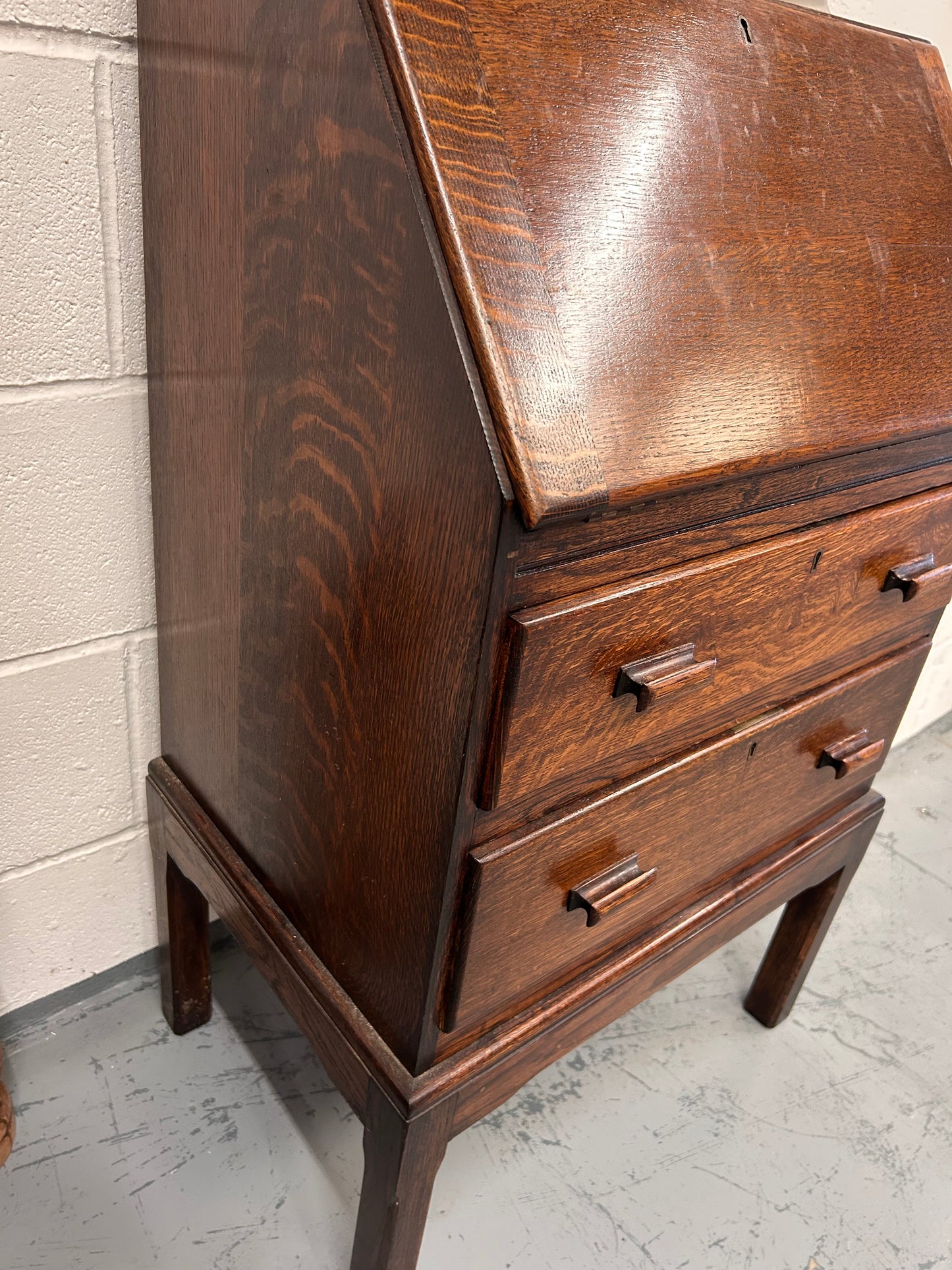 A lovely little vintage compact oak bureau with drop down writing surface and storage
