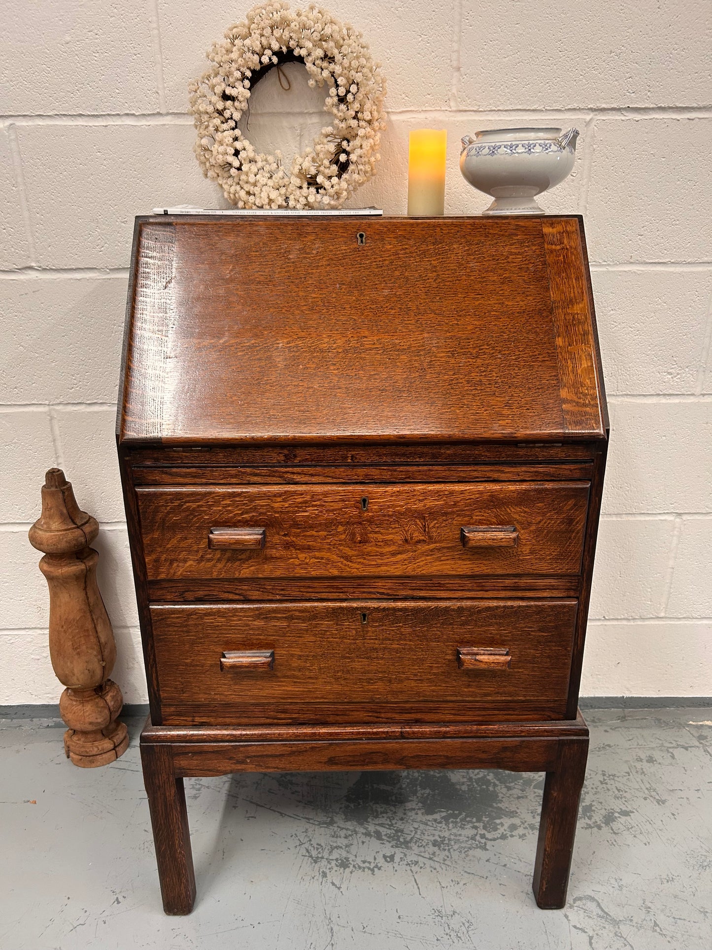 A lovely little vintage compact oak bureau with drop down writing surface and storage