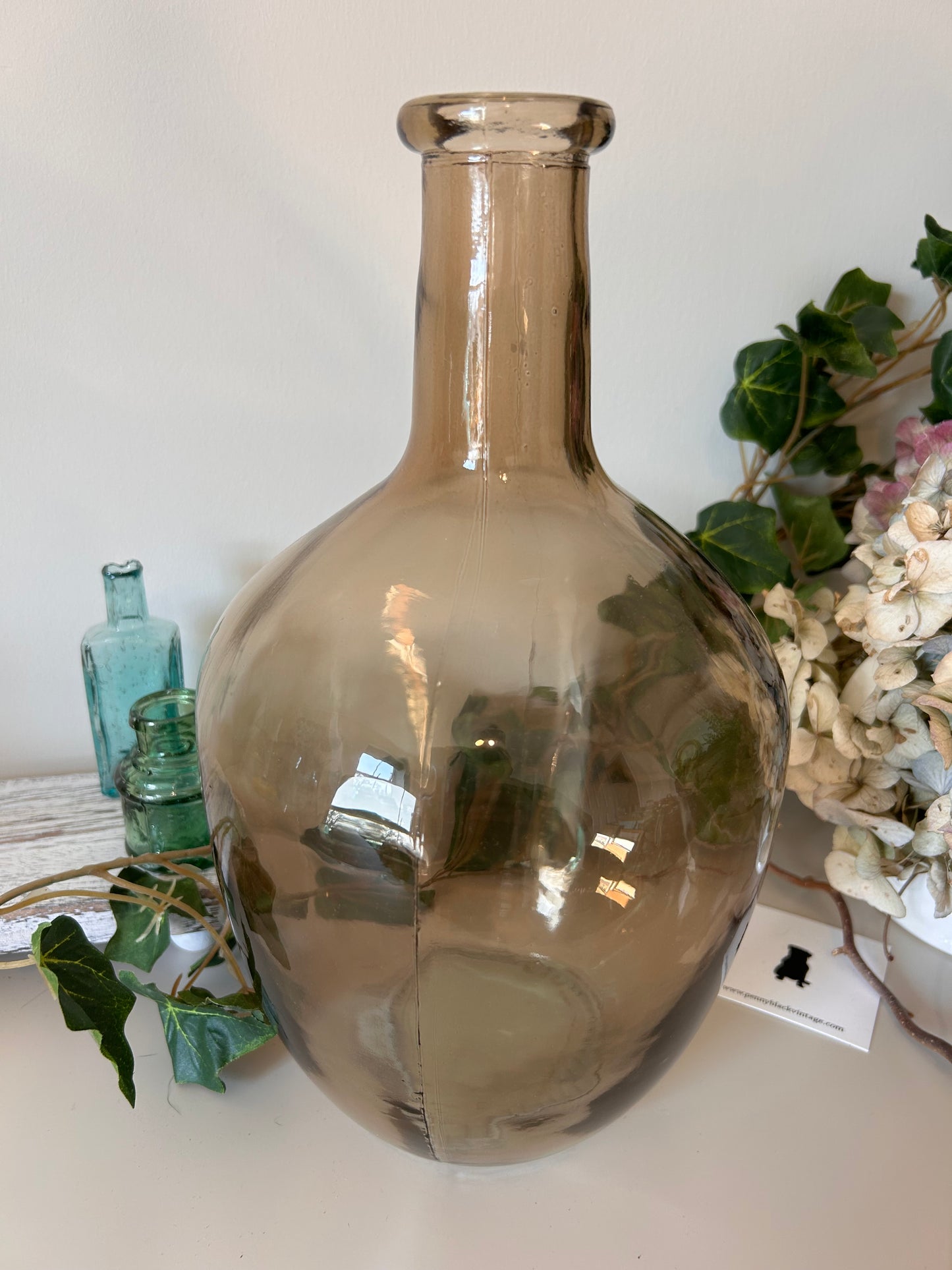 A vintage style amber bottle made from recycled glass