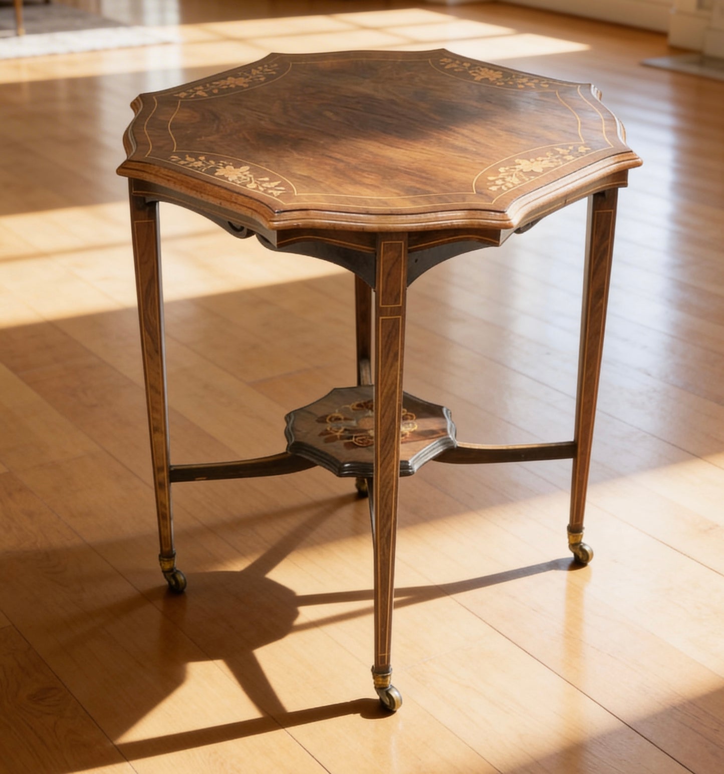 Edwardian inlaid rosewood centre table, octagonal top, square taper legs and undertier