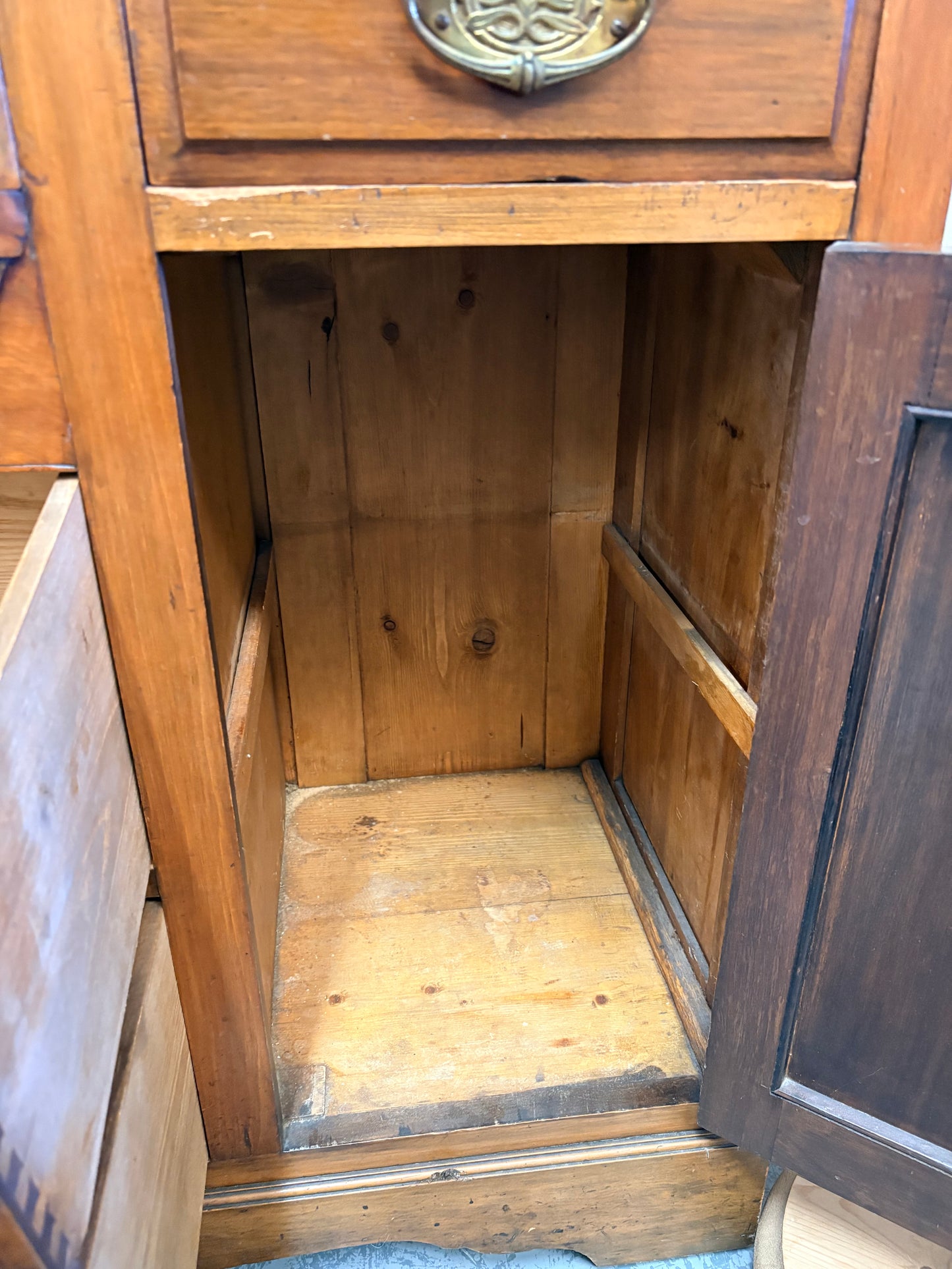 Edwardian Walnut sideboard featuring carved floral panels doors and brass hardware