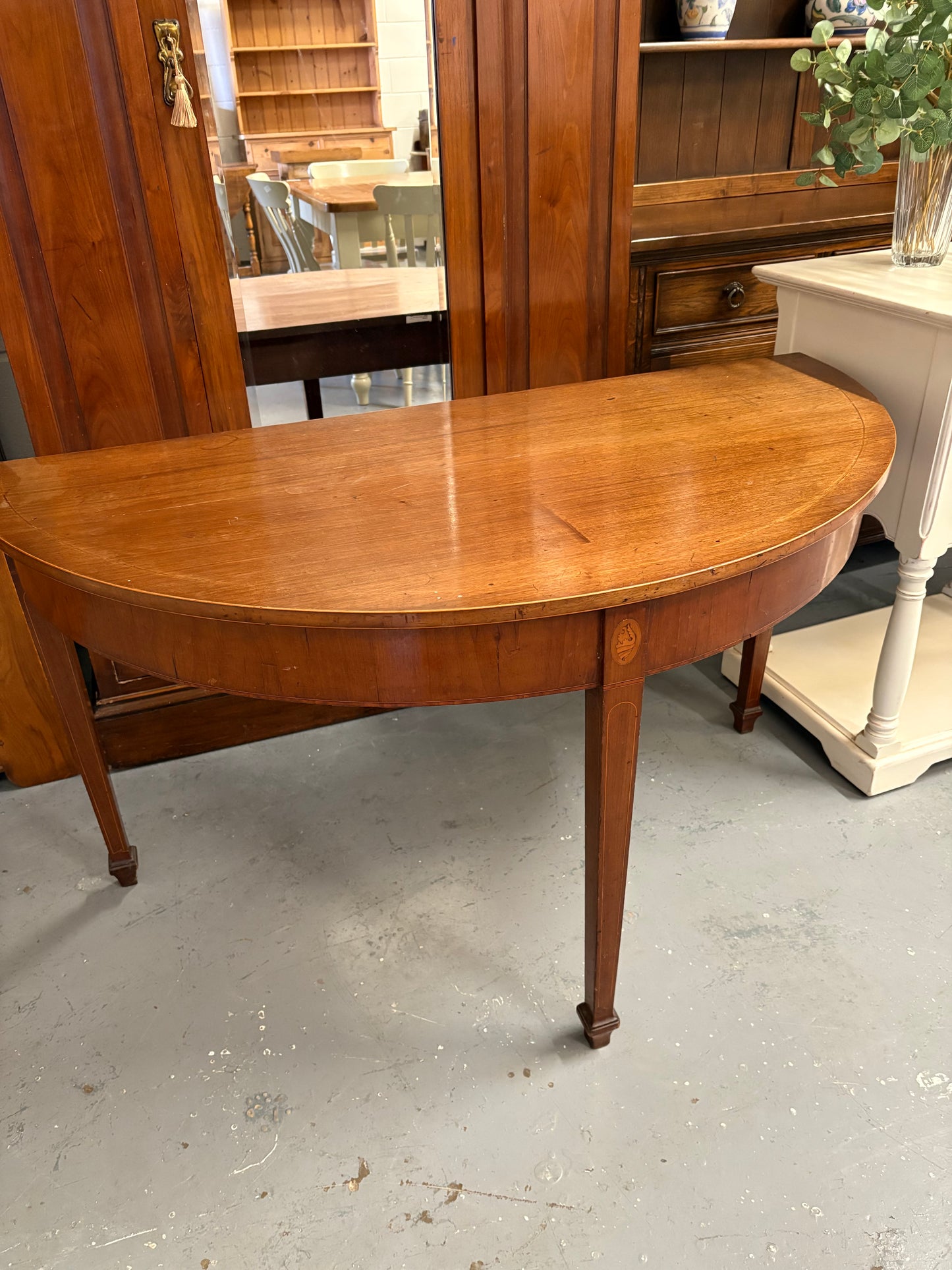 A 19th century mahogany demi-lune console table with rounded top