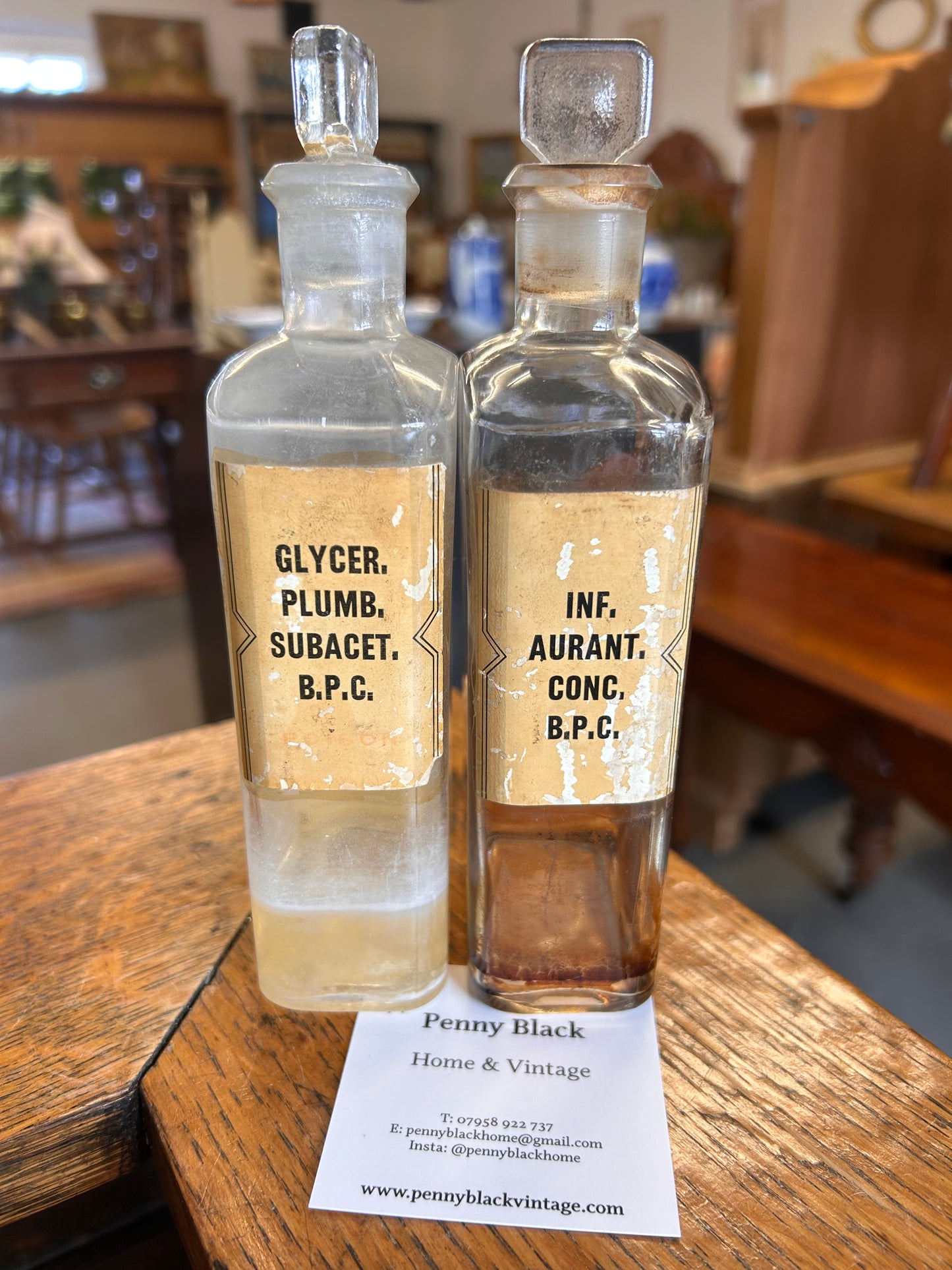 Pair of Victorian apothecary chemists bottles with labels and ground glass stoppers.