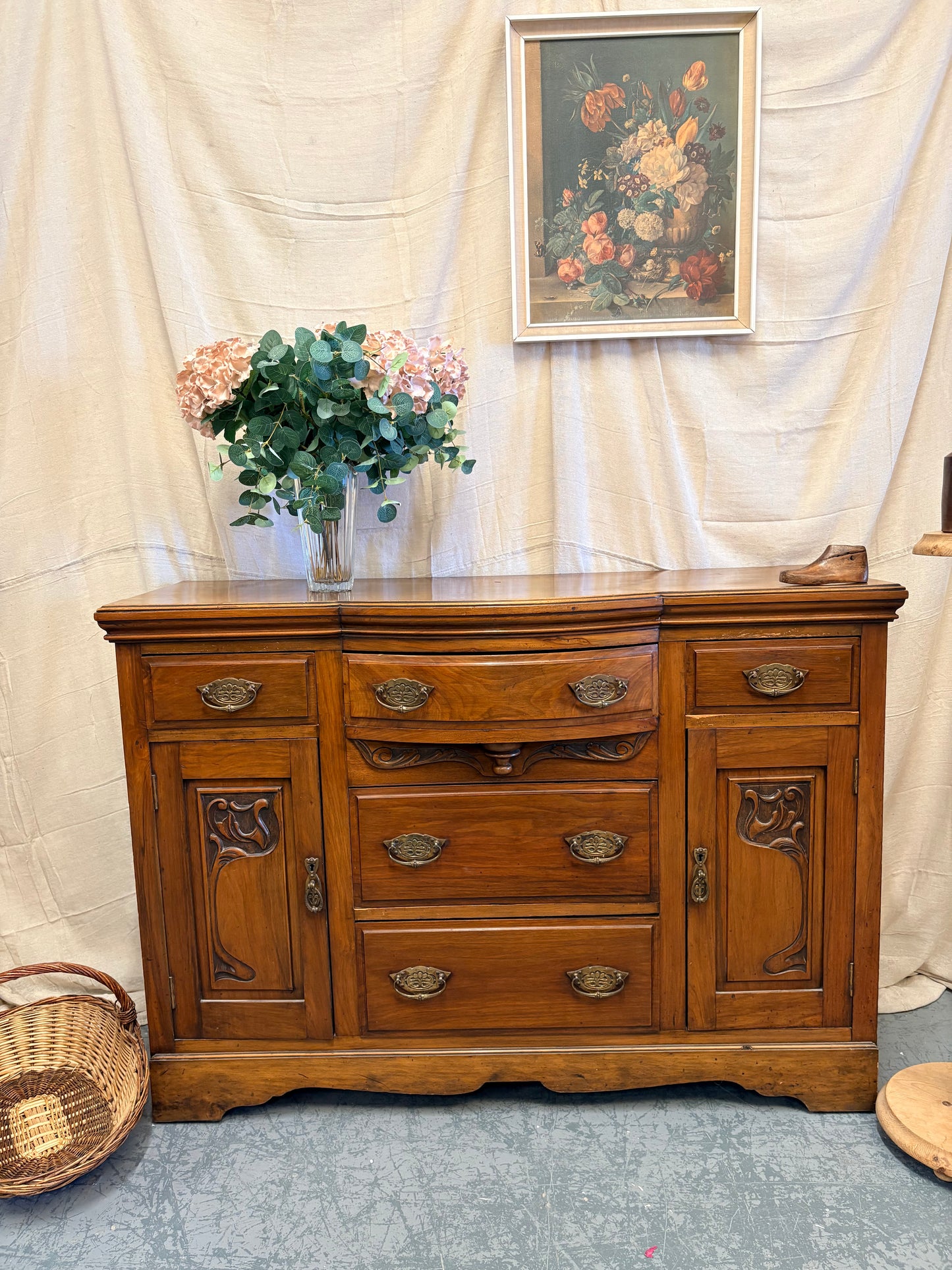 Edwardian Walnut sideboard featuring carved floral panels doors and brass hardware