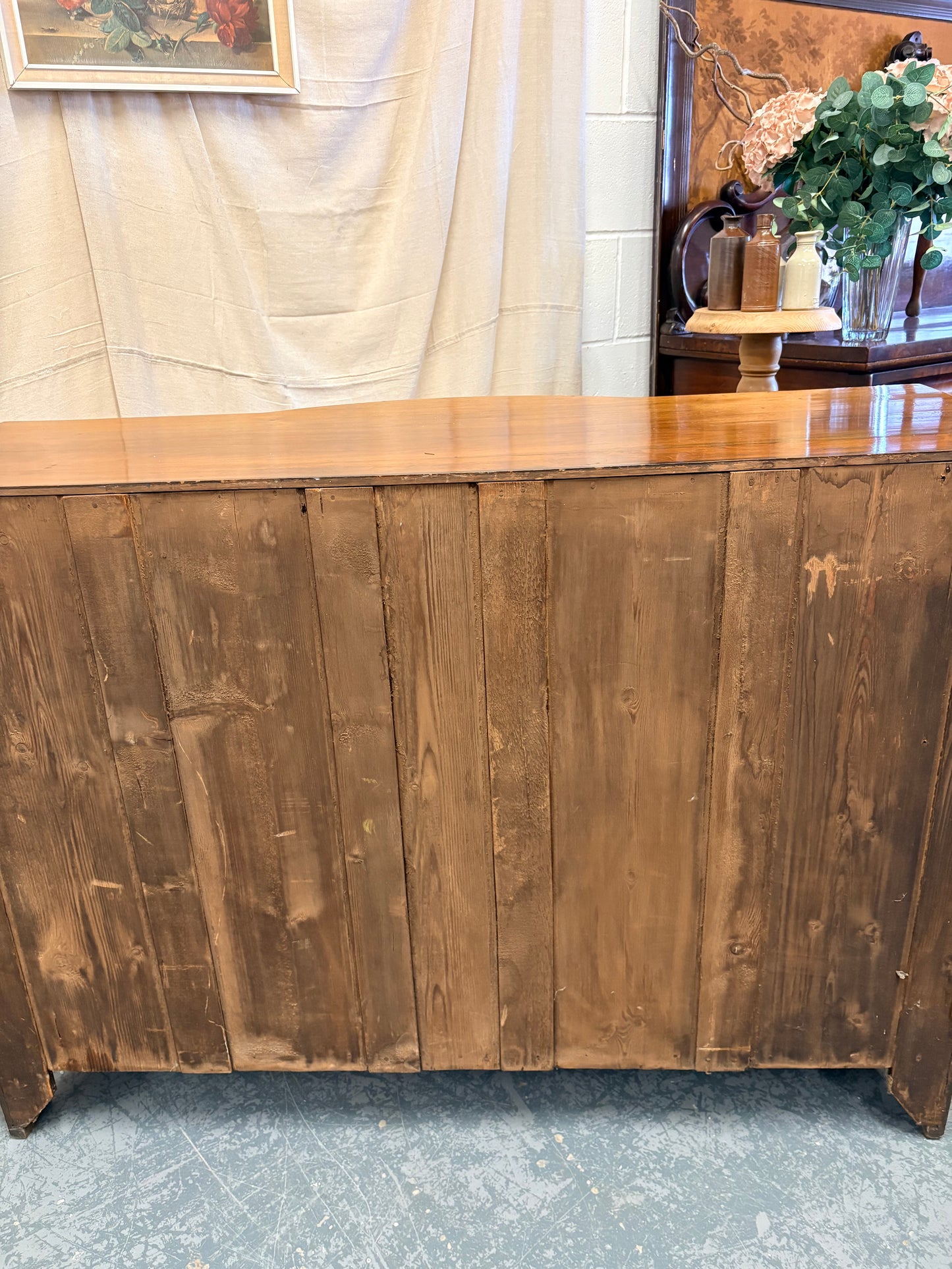 Edwardian Walnut sideboard featuring carved floral panels doors and brass hardware