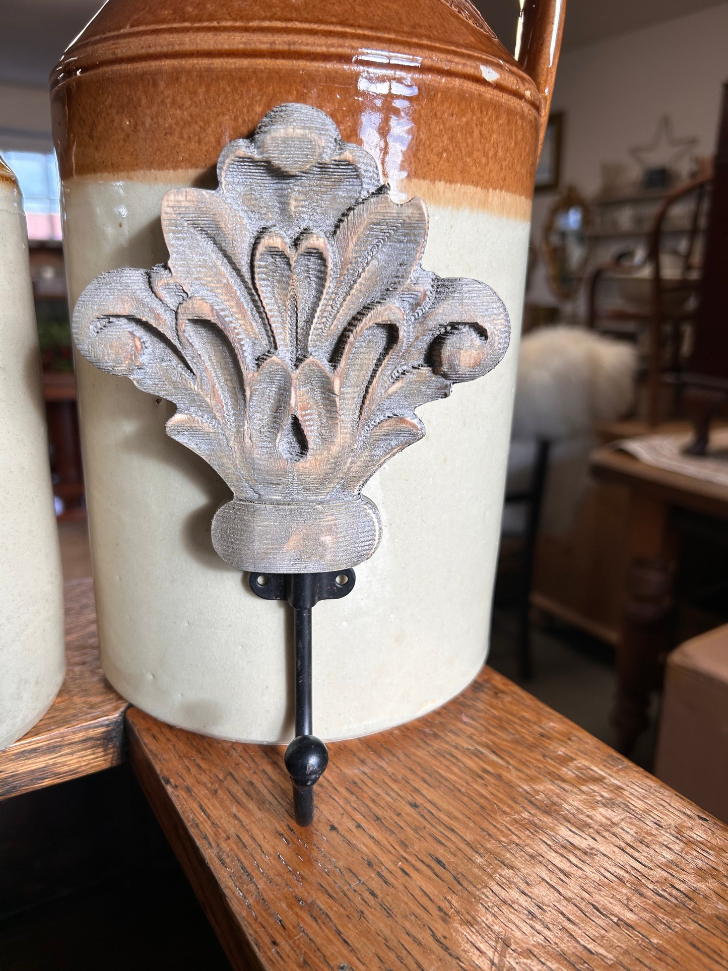 Taupe wood acanthus and black metal wall hook