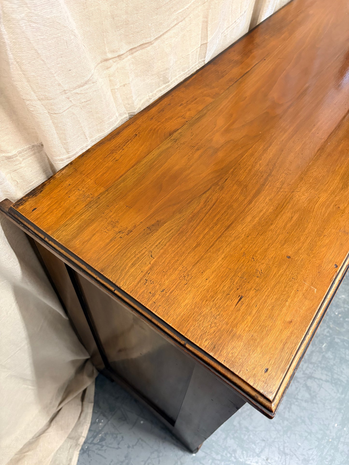 Edwardian Walnut sideboard featuring carved floral panels doors and brass hardware