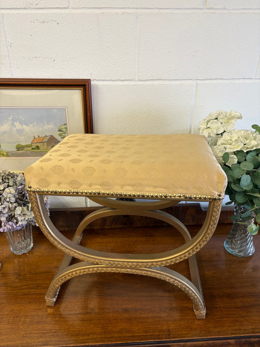 Vintage Regency Yellow Gold upholstered stool with a cross X Frame
