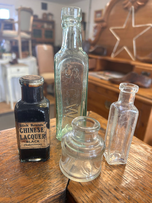 A collection of four vintage original glass bottles for quirky display