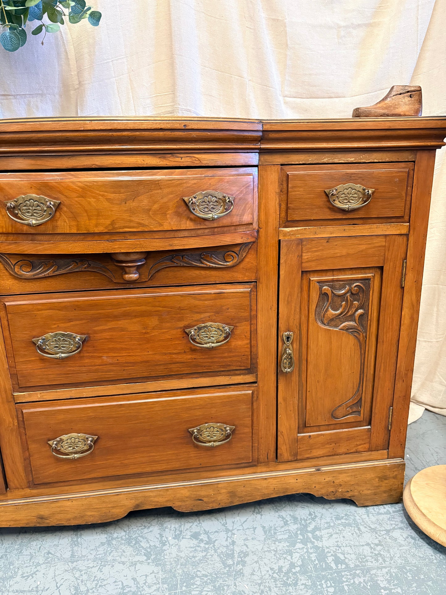 Edwardian Walnut sideboard featuring carved floral panels doors and brass hardware