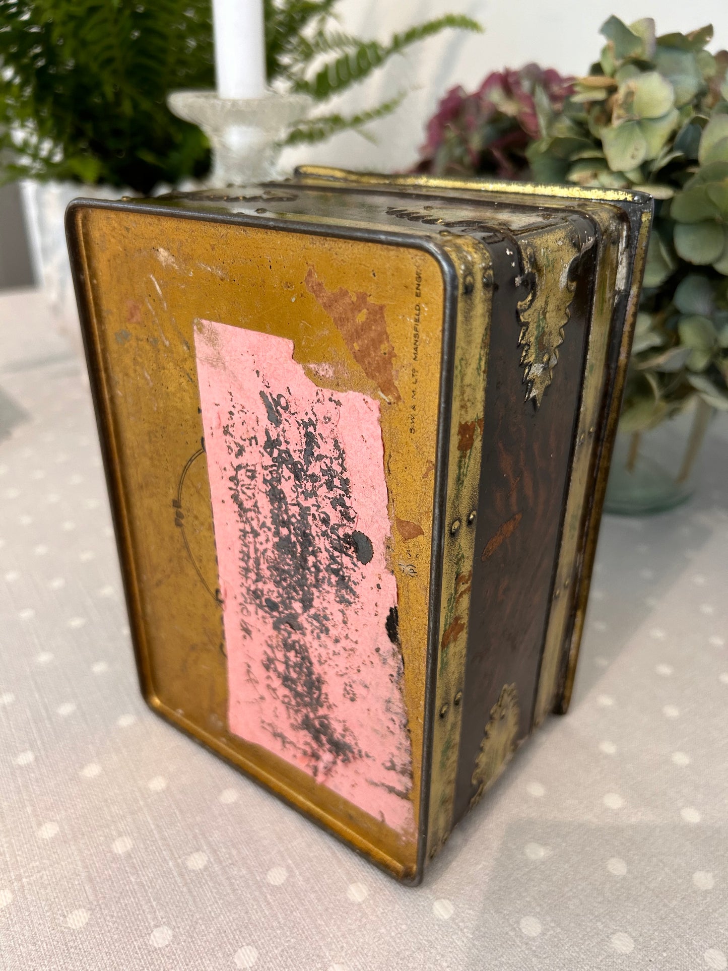 A vintage metal tin storage box resembling brass mounted wood.