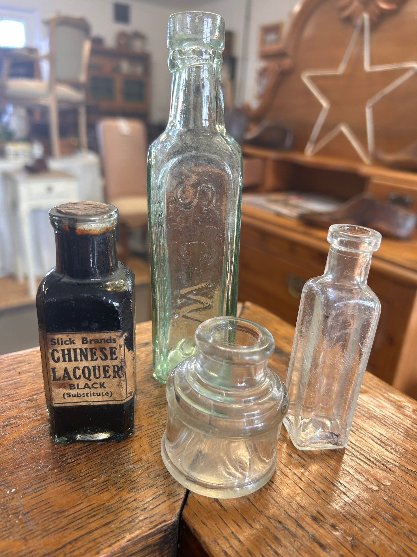 A collection of four vintage original glass bottles for quirky display