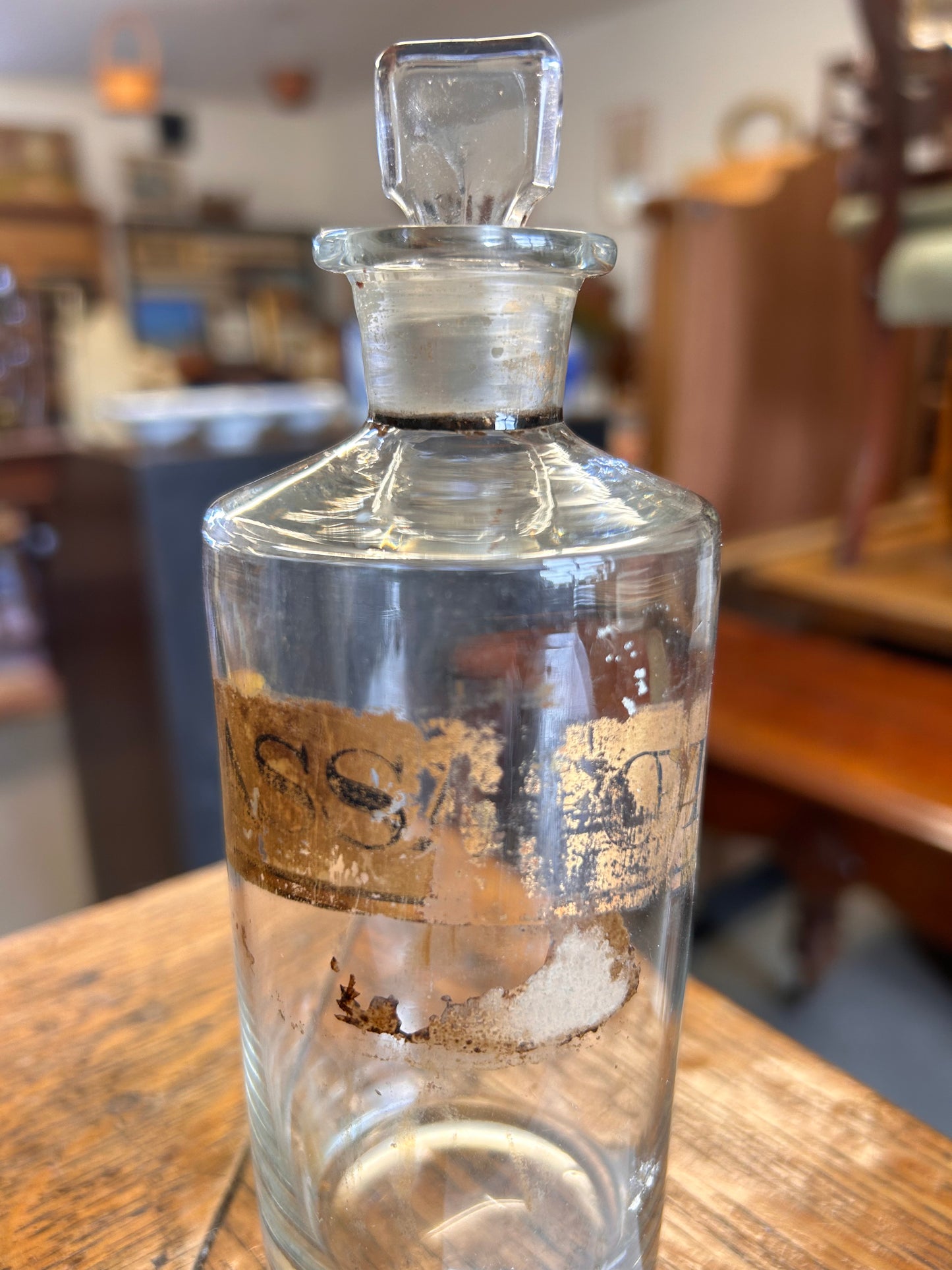 A Victorian apothecary chemists bottle with label and ground glass stopper.