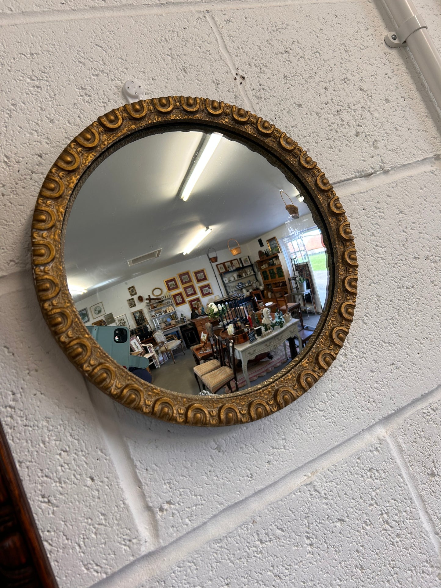 Fabulous circular convex mid-century gilt framed mirror.