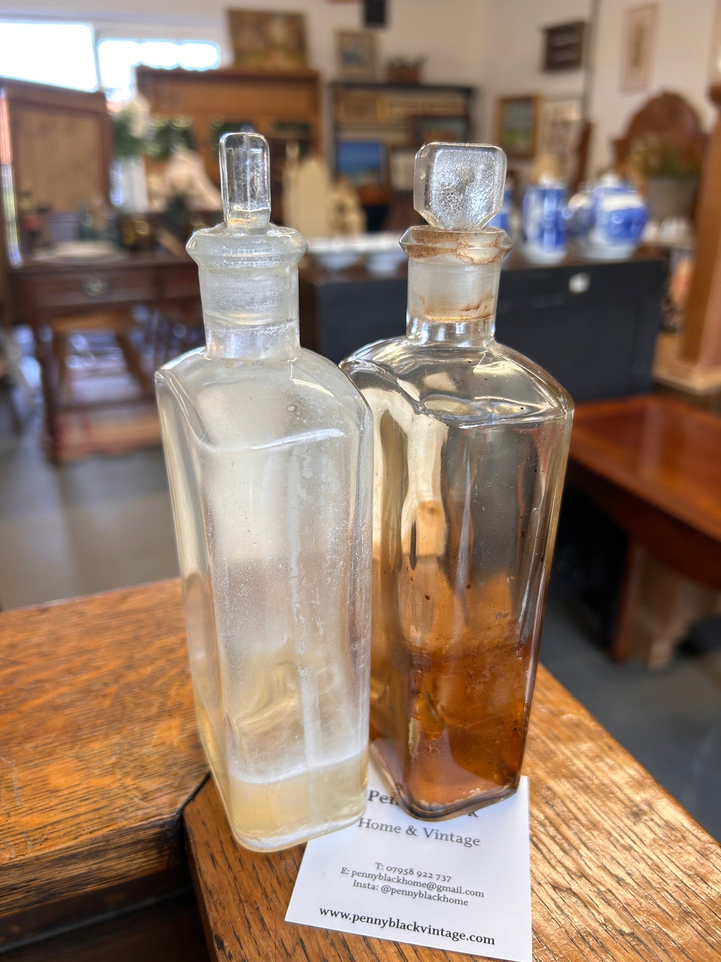 Pair of Victorian apothecary chemists bottles with labels and ground glass stoppers.