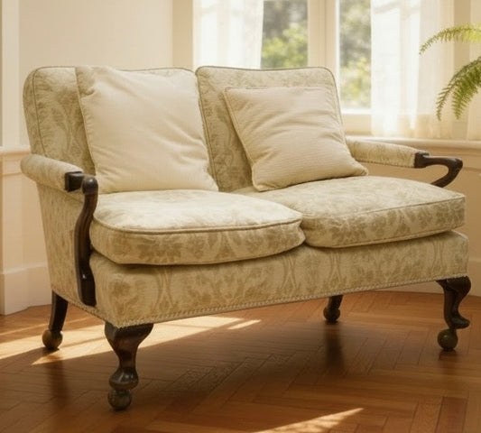 Georgian design mahogany framed settee, with pale green floral patterned upholstery, scroll carved arms