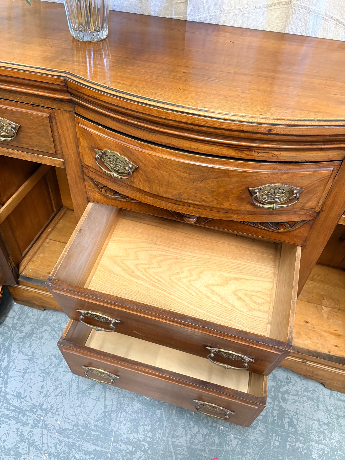 Edwardian Walnut sideboard featuring carved floral panels doors and brass hardware
