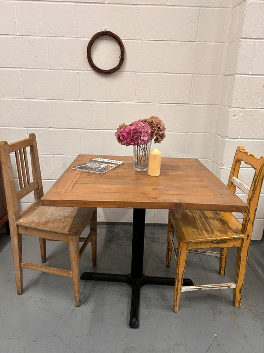 Preloved Rustic four seater table with thick wooden top and black metal base.