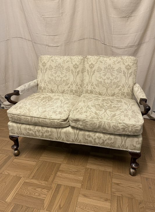 Georgian design mahogany framed settee, with cream floral patterned upholstery, scroll arms