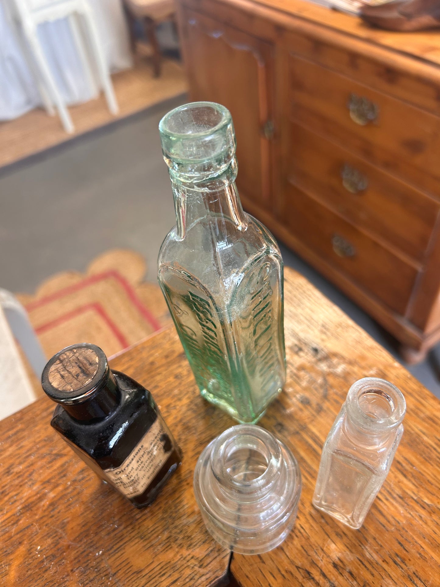 A collection of four vintage original glass bottles for quirky display