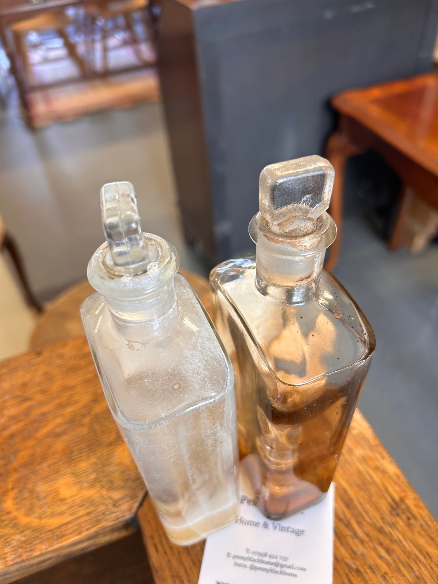 Pair of Victorian apothecary chemists bottles with labels and ground glass stoppers.