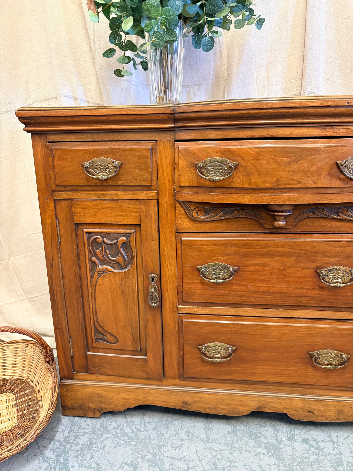 Edwardian Walnut sideboard featuring carved floral panels doors and brass hardware