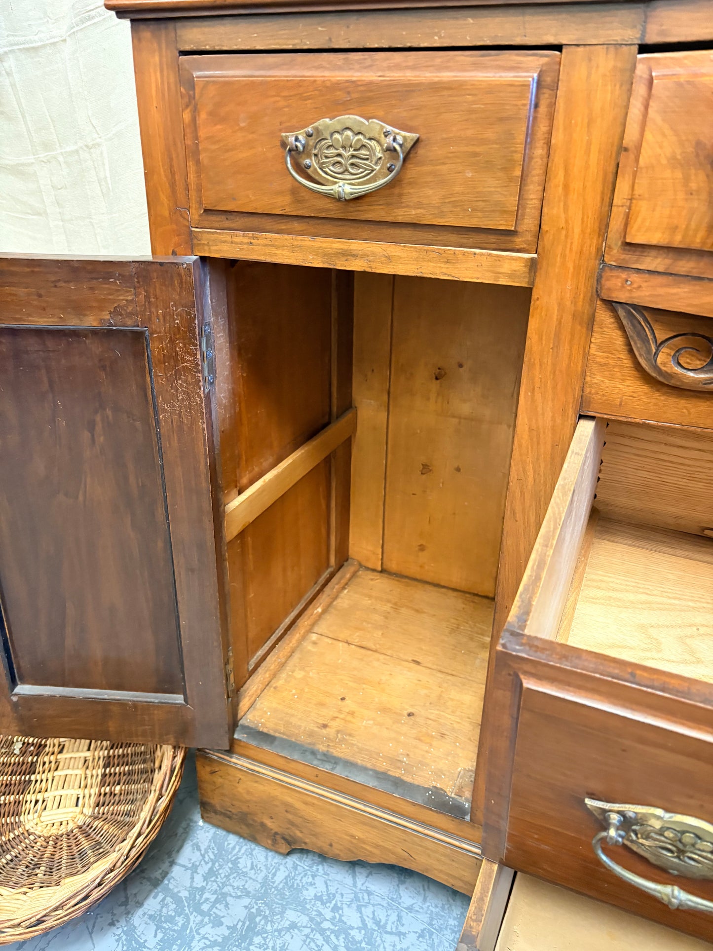 Edwardian Walnut sideboard featuring carved floral panels doors and brass hardware