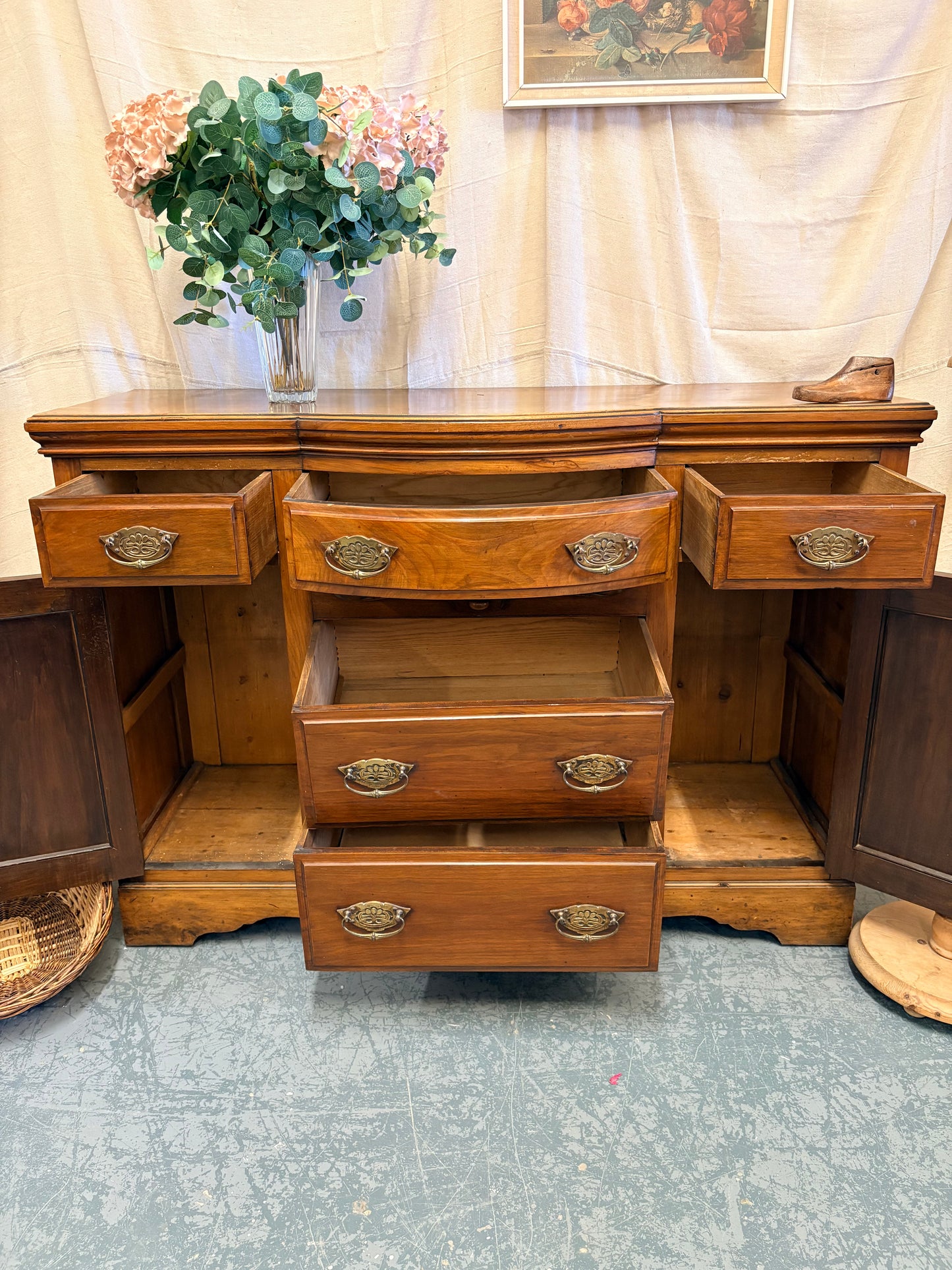 Edwardian Walnut sideboard featuring carved floral panels doors and brass hardware