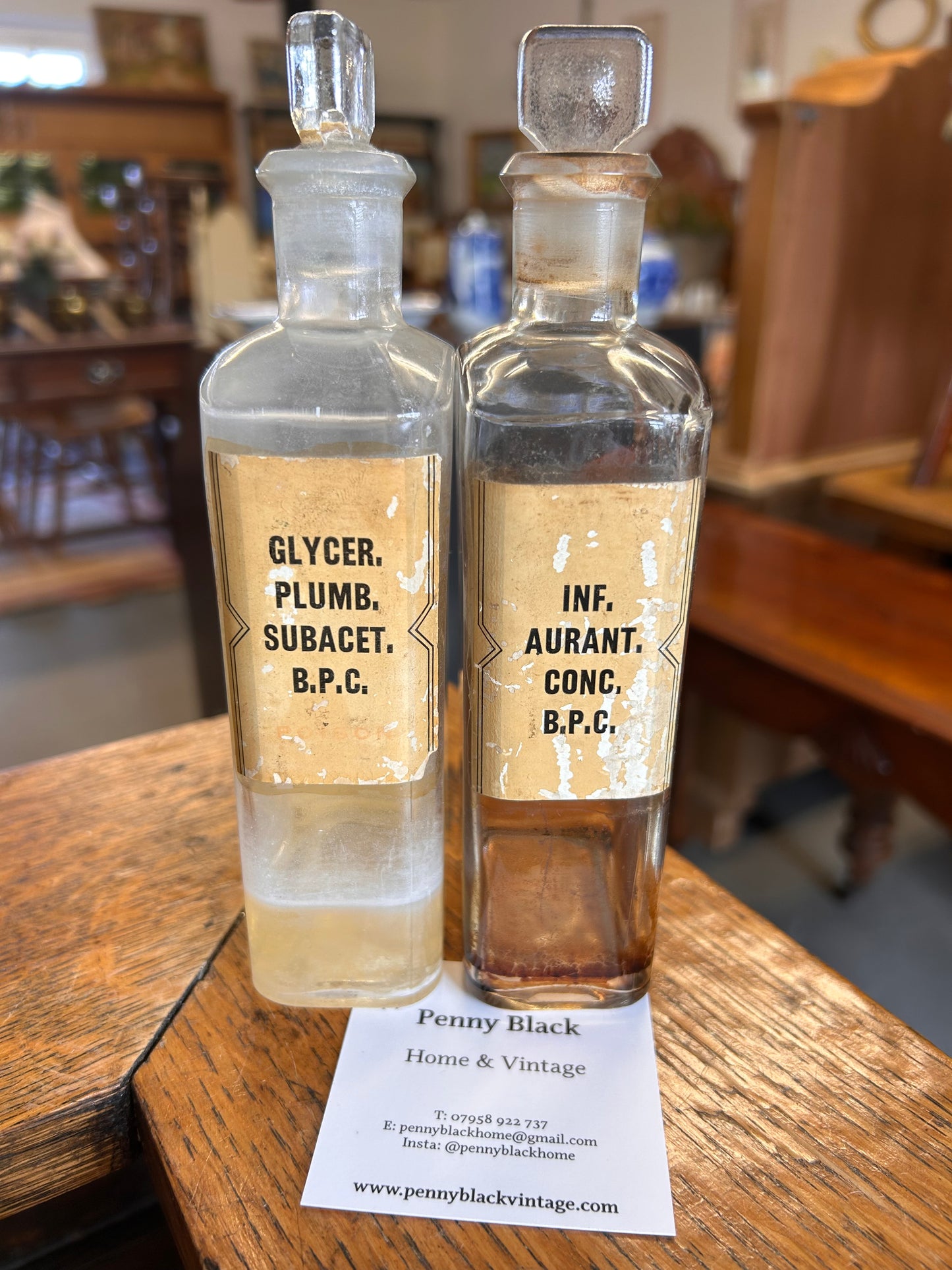 Pair of Victorian apothecary chemists bottles with labels and ground glass stoppers.